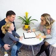 therapist talking to father and child