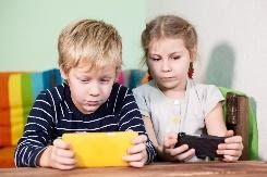 children looking at smartphones